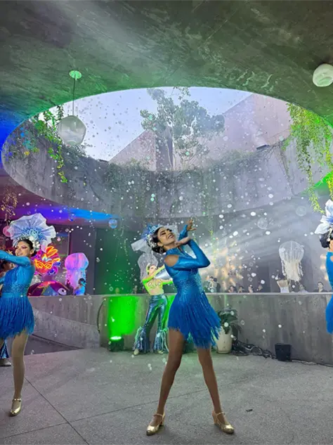 Dancers in blue costumes at the opening event